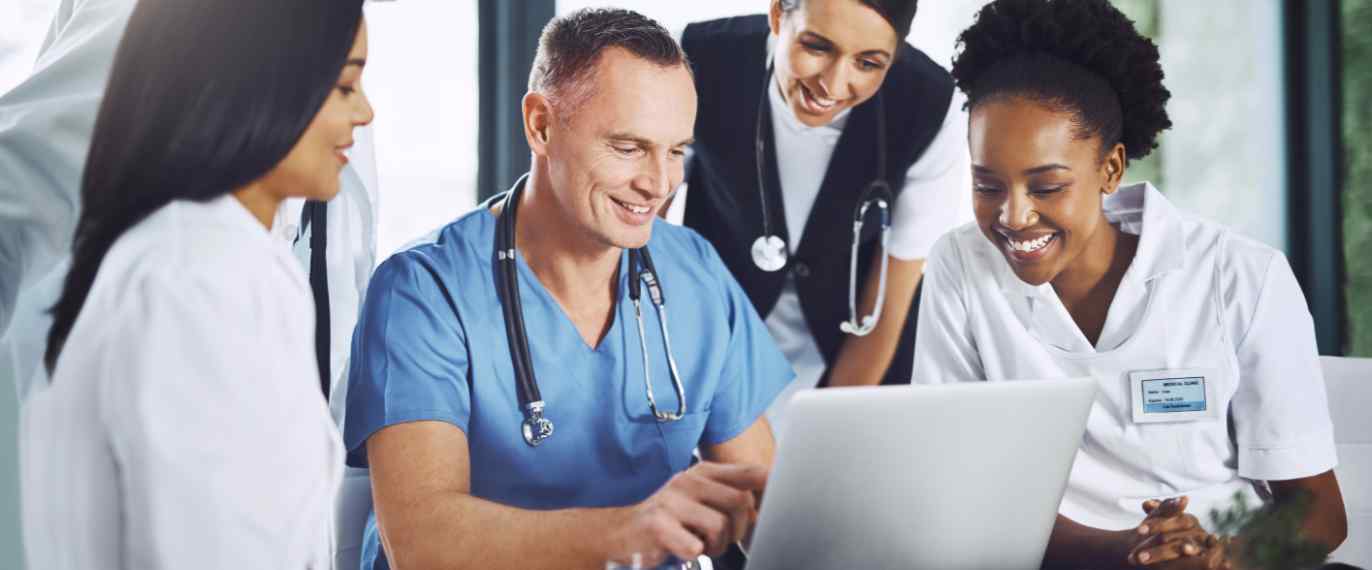 Doctors smiling at a computer