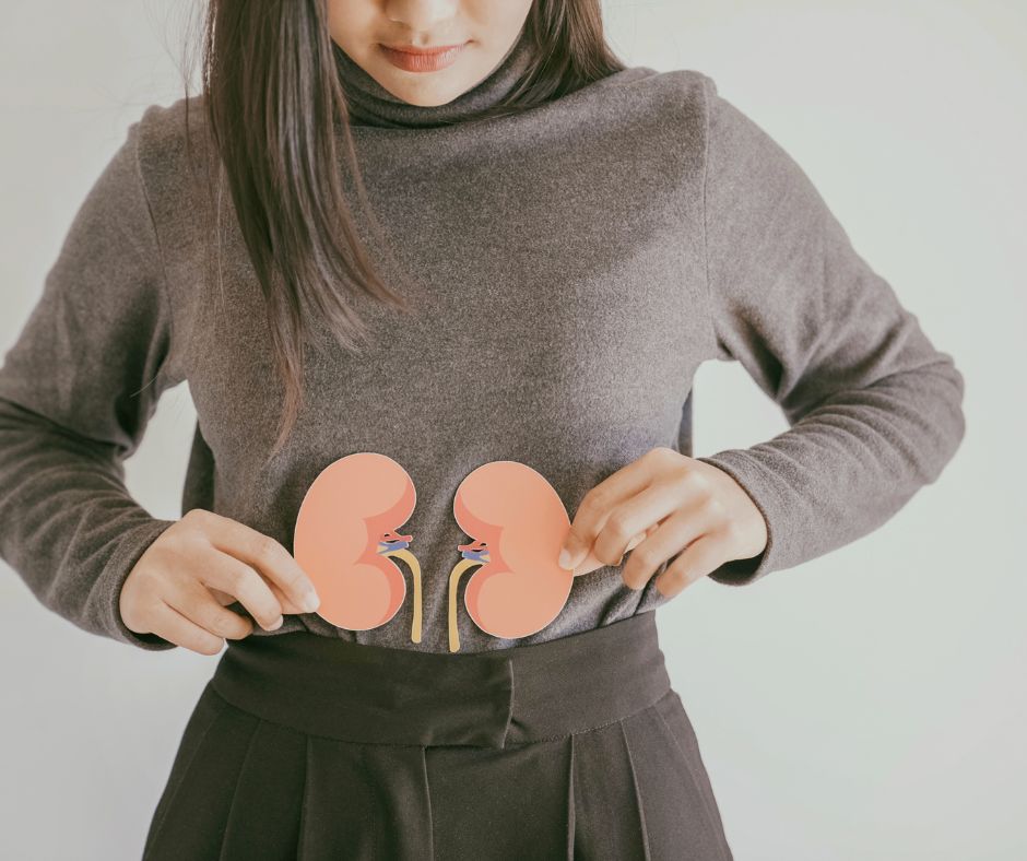Woman holding Kidney graphic in front of her